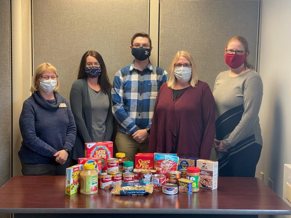 Betsy, Dawn, Kade, Denise, And Christina are at the branch location with part of the donation to the Moose Lake Food Shelf