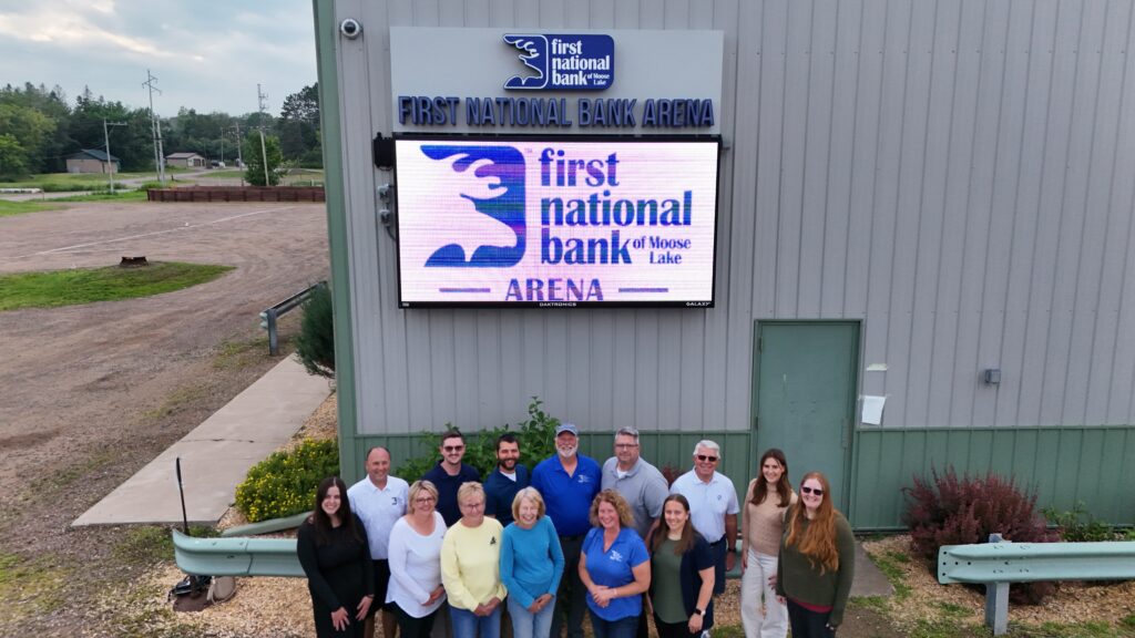 Group picture taken outside of the First National Bank Arena.
